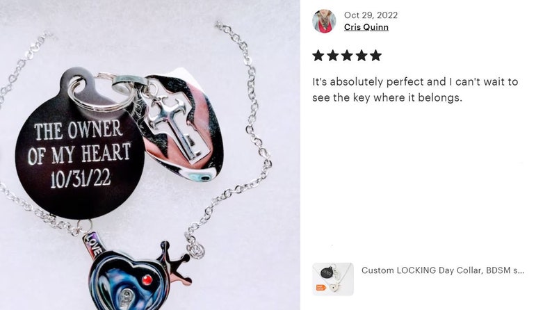 May include: A silver-toned chain necklace featuring a round black pendant engraved with the text THE OWNER OF MY HEART and 10/31/22. Attached are a silver key-shaped charm and a heart-shaped charm with a crown detail and a small red accent.