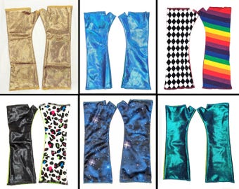 May include: Six pairs of fingerless gloves in various colors and patterns. The gloves include gold, blue, black, a black and white diamond pattern, a rainbow stripe pattern, a leopard print, a starry night design, and teal.
