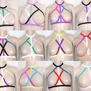 May include: A collection of halter tops in various colors, including black, white, pink, purple, green, and yellow. Each top features a unique strap design and a choker-style neckline. The tops are displayed on mannequins.