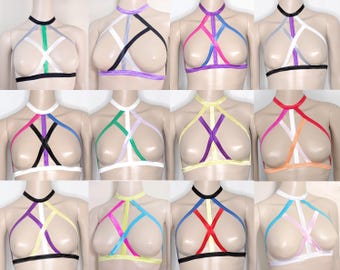 May include: A collection of halter tops in various colors, including black, white, pink, purple, green, and yellow. Each top features a unique strap design and a choker-style neckline. The tops are displayed on mannequins.