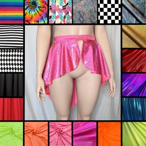 May include: A bright pink holographic skirt with a high-low hemline and a front opening. The skirt features a metallic, reflective finish that catches the light, creating a shimmering effect across the fabric surface and a structured waistband.