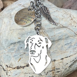 May include: Silver keychain with a dog silhouette charm, a small angel wing charm, and a heart-shaped charm with the text "I will hold you in my heart until I hold you in heaven".