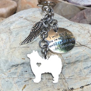 May include: Silver keychain with a small angel wing charm, a round charm with the text "I will hold you in my heart until I hold you in heaven", and a white silhouette of a dog with a heart cutout.