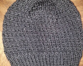 May include: A gray knitted beanie hat with a flecked texture.