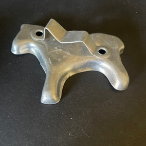 May include: A silver metal cookie cutter shaped like a horse. The cutter has two holes on the top for hanging.