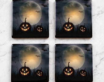 May include: A set of four square coasters featuring a Halloween scene with two glowing jack-o'-lanterns, a large full moon, and silhouettes of flying bats against a dark, moody sky. Each coaster displays the same detailed spooky graphic design.