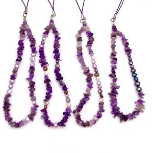 May include: Four purple and white gemstone phone charms with a silver loop. Each charm is made of small, irregular shaped beads.