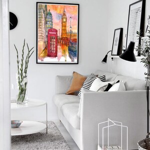 May include: A watercolor painting of Big Ben and a red telephone booth in London, England. The painting is framed and hanging on a white wall in a living room.