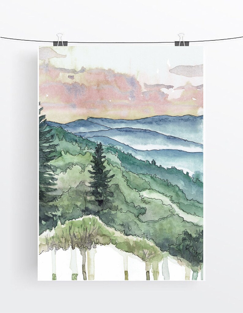 May include: Watercolor painting of a mountain landscape with a pink and orange sunset sky. The mountains are covered in green trees and there is a layer of fog in the valleys.
