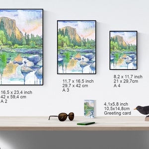 Peut inclure: Une peinture &agrave; l'aquarelle d'un paysage de montagne avec une rivi&egrave;re au premier plan. La peinture est disponible en plusieurs tailles, y compris une carte de v&oelig;ux.