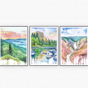 May include: Three watercolor paintings of landscapes. The first painting shows a mountain range with a pink and orange sunset sky. The second painting shows a river with a mountain in the background. The third painting shows a waterfall in a canyon.