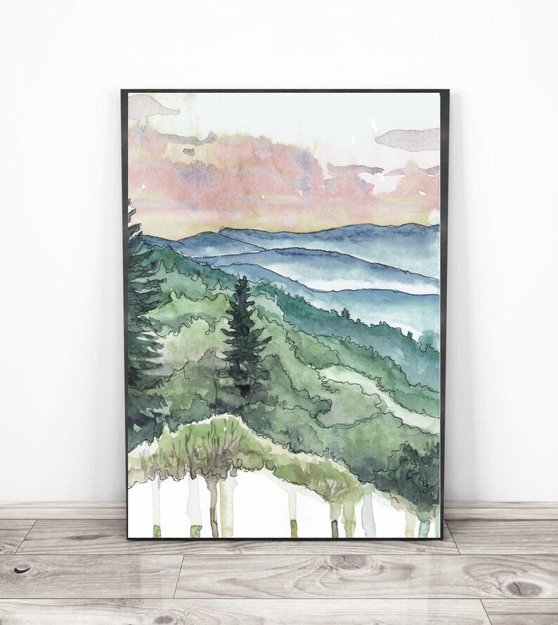 May include: Watercolor painting of a mountain landscape with a pink and purple sky. The mountains are covered in green trees and there is a layer of fog in the valleys.