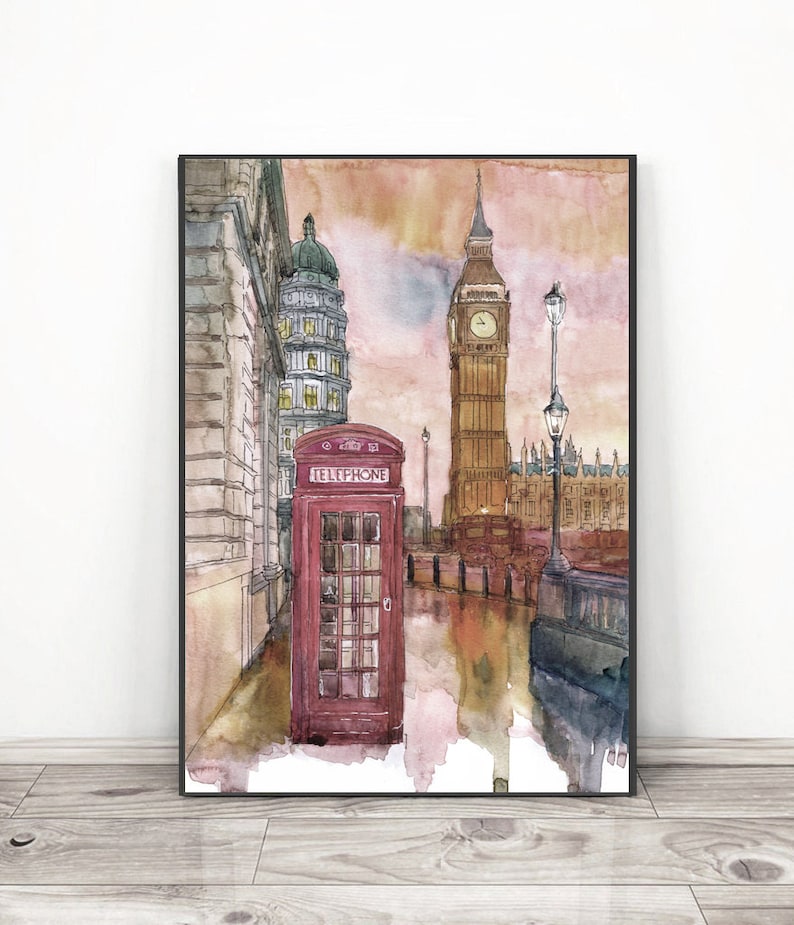 May include: A watercolor painting of Big Ben and the Houses of Parliament in London, England. A red telephone booth is in the foreground, with a street lamp and a bus in the background. The sky is a soft orange and pink.
