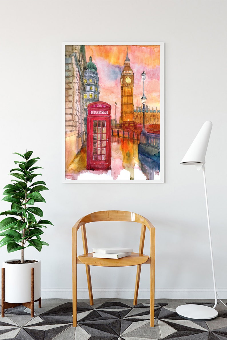 May include: A watercolor painting of Big Ben and the Houses of Parliament in London, England. A red telephone booth is in the foreground. The sky is a vibrant orange and pink.