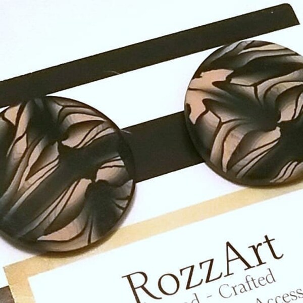 Handmade, Avant-garde black & cream color round polymer clay earrings. Surgical steel posts for sensitive ears. Light weight and comfortable