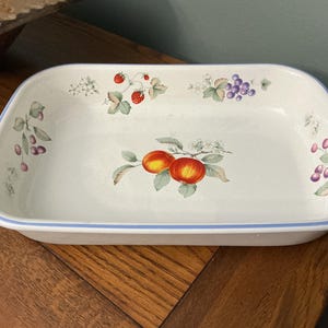 May include: A set of three ceramic mugs with a speckled, matte finish. The mugs are in shades of cream, light gray, and dark gray. Each mug has a simple, minimalist design and a rounded handle.