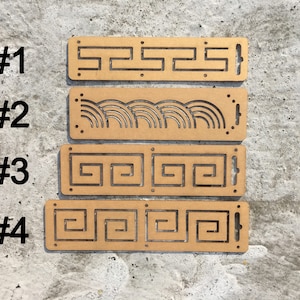 May include: Four wooden plaques with different geometric patterns cut out. The plaques are numbered 1 through 4.