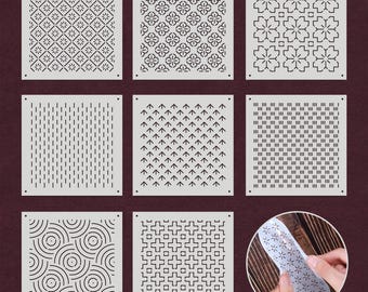 May include: Nine different stencils with geometric patterns. The stencils are made of white plastic and are approximately 4 inches by 4 inches. The patterns include circles, squares, diamonds, and arrows.