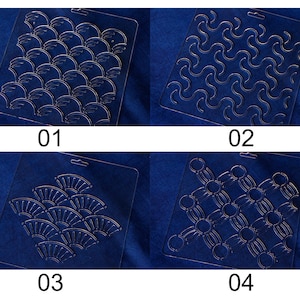 May include: Four clear plastic stencils with different geometric patterns. The stencils are numbered 01 through 04.