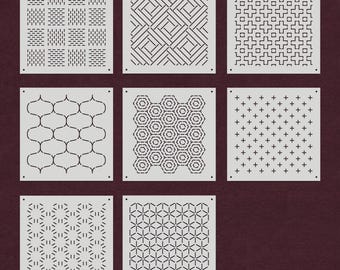 May include: A set of nine white square tiles with different geometric patterns in black. The patterns include lines, squares, hexagons, and stars.