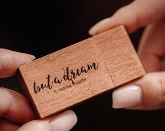May include: A wooden USB flash drive with the text "but a dream by Angelina Alexander" engraved on it.