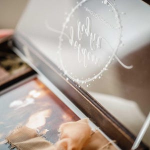 Close-up inside view of acrylic lid engraving over a 4x6 print in the wooden photo box.