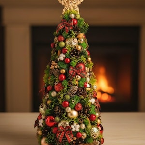 May include: A conical artificial Christmas tree decorated with red and gold ornaments, pinecones, cotton bolls, and plaid fabric bows. The tree is topped with a woven star ornament and features a dense arrangement of green foliage and berries.