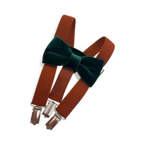 May include: A white ceramic mug with a black handle and the text "But First, Coffee" in a bold, black font. The mug is set against a blurred background, suggesting a cozy setting.