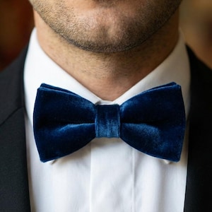 May include: A set of three ceramic mugs with a speckled, matte finish. The mugs are in shades of cream, light gray, and dark gray. Each mug has a simple, minimalist design, perfect for coffee or tea.