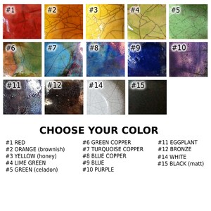 May include: A colour chart displaying fifteen textured colour swatches. The colours include red, orange, yellow, lime green, green, green copper, turquoise copper, blue copper, blue, purple, aubergine, bronze, white, and black.