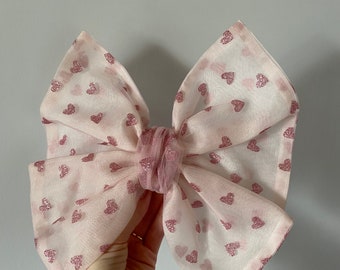 Large pink tulle hair bow with glitter hearts