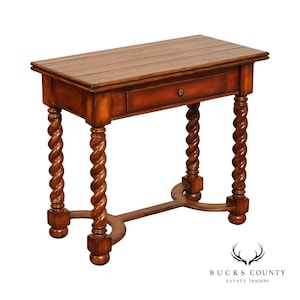 May include: A rectangular wooden side table with a warm brown finish, featuring a single drawer with a small round knob. The table is supported by four barley twist legs connected by a curved H-shaped stretcher base with rounded feet.