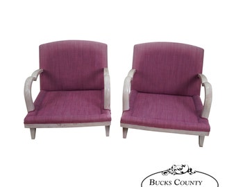 May include: A pair of vintage armchairs with white painted wooden frames and pink fabric upholstery. The chairs have curved armrests and a simple, elegant design.