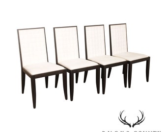 May include: Set of four dining chairs with a white upholstered seat and back, and a dark brown wood frame.