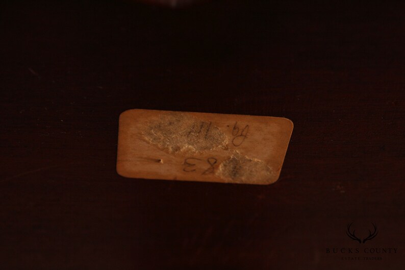May include: A brown paper tag with handwritten text that reads "11-84 E81".