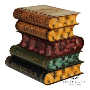 May include: A stack of four decorative books with titles: "ARTS", "DANTE", "PHILOSOPHY", and "ARCHEOLOGY". The books have a distressed, antique appearance with brown, green, and burgundy tones. The edges of the books have a yellow and black pattern.