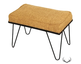 May include: A mid-century modern style bench with a mustard yellow fabric seat and black metal hairpin legs.