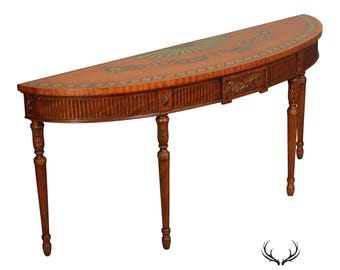 May include: A semi-circular wooden console table featuring a light brown finish with a decorative painted fan motif on the top surface. The table has four fluted legs and a central carved drawer front with vertical reeded detailing along the apron.