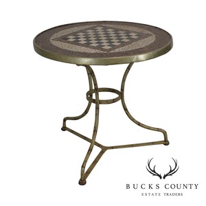 May include: Round mosaic-top side table with a chess board design in the center. The table has a metal frame with a distressed, aged finish. The table is approximately 24 inches in diameter and 20 inches tall.