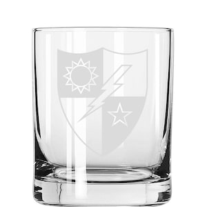 May include: A clear glass tumbler with an etched design of a shield with a lightning bolt, a star, and a sun.