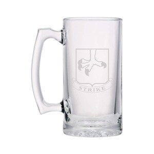 May include: A clear glass beer mug with a handle. The mug has an etched design of a bird's claw and the word "STRIKE" underneath.