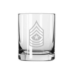 May include: A clear glass tumbler with an etched design of a military rank insignia. The insignia features a star and five chevrons.