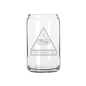 May include: A clear glass can with an etched design of the 3rd Infantry Division's insignia, a triangle with a lightning bolt and crossed cannons, and the text "SPEARHEAD".