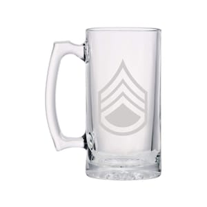 May include: A clear glass beer mug with a handle. The mug has a white etched design of a military rank insignia, a Sergeant's chevron.
