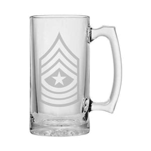 May include: A clear glass beer mug with a handle. The mug has an etched design of a military rank insignia with a star.