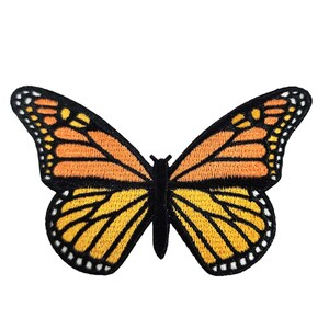 May include: A yellow and orange butterfly with black outlines and white dots. The butterfly is embroidered and has a detailed design.