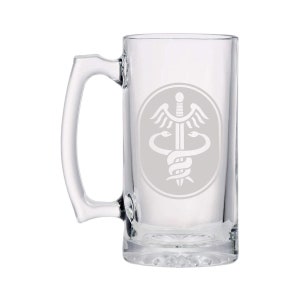 May include: A clear glass beer mug with a handle. The mug has a white etched design of the medical symbol, a snake wrapped around a staff with wings.
