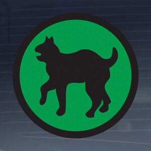 May include: A black silhouette of a dog on a green circle with a black border.