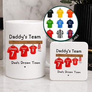 May include: A white ceramic mug and a matching square coaster, both featuring the text Daddy's Team and Dad's Dream Team above an illustration of three red jerseys hanging on a rack with the names Daddy, Sophie, and Colby and numbers 7, 7, and 9.