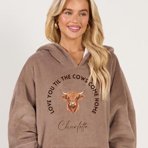 May include: A brown oversized hoodie with a cow graphic and the text "Love you til the cows come home" and the name "Charlotte".